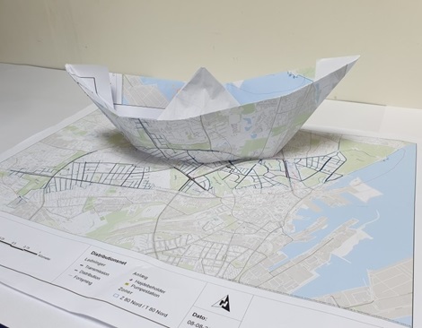 A paper ship shaped from a water network map